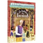 Couverture d'un livre intitulé 'La boutique des Émotions', illustrant un homme âgé et un jeune garçon, avec un décor de boutique vibrant et coloré.