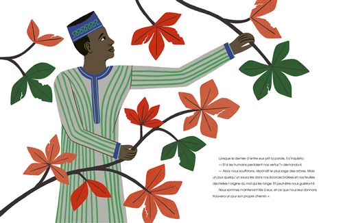 Un homme en tenue traditionnelle tient des branches avec des feuilles rouges et vertes, tandis qu'il observe son environnement.